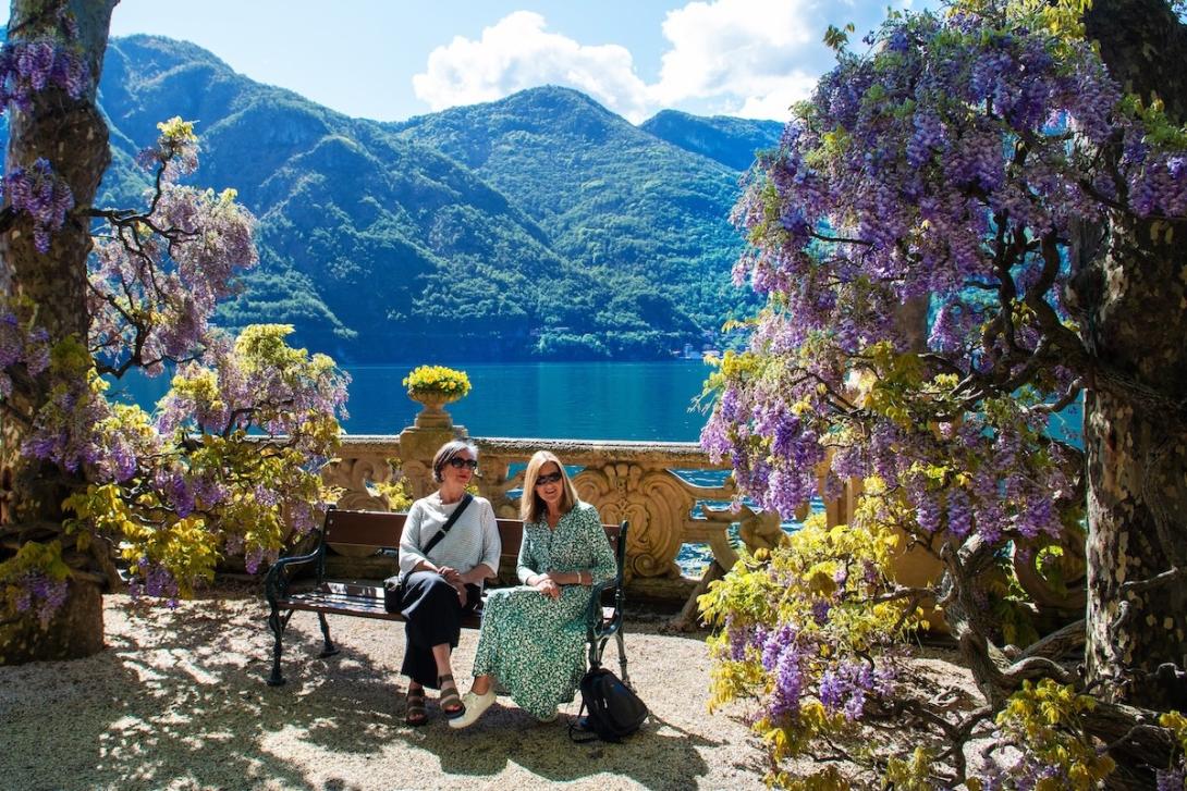 (credit: Riviera Travel) Two women sitting on a bench with picturesque Italian lake behind them