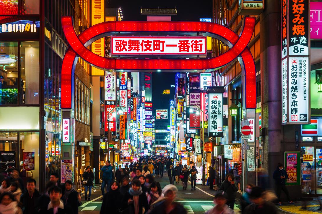 (credit: Riviera Travel / Getty Images) Neon lights and illuminated billboards of Shinjuku glittering at night above crowds of shoppers in the heart of Tokyo