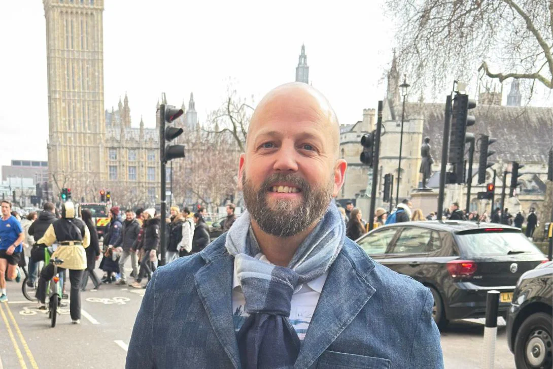 Man smiling on busy London road