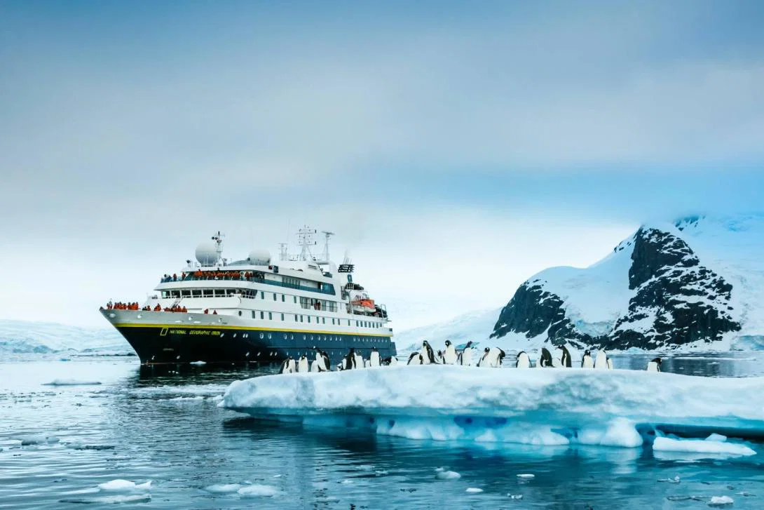 National Geographic-Lindblad Expeditions cruise ship in Antarctica with penguins National Geographic-Lindblad Expeditions cruise ship in Antarctica with penguins