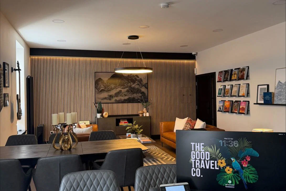 Fancy client lounge with brown sofa and wood dining table