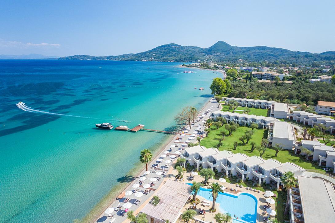 (credit: Domes Resorts) A drone view of Domes Miramare Corfu with ocean, beach, sunbeds and pool