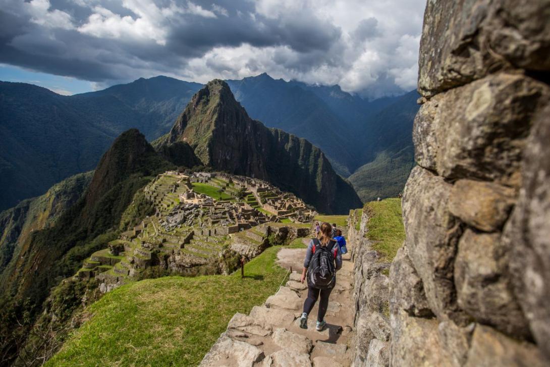 (credit: Metropolitan Touring) People walking towards Machu Picchu, a stone ruin set among Peru's green mountains