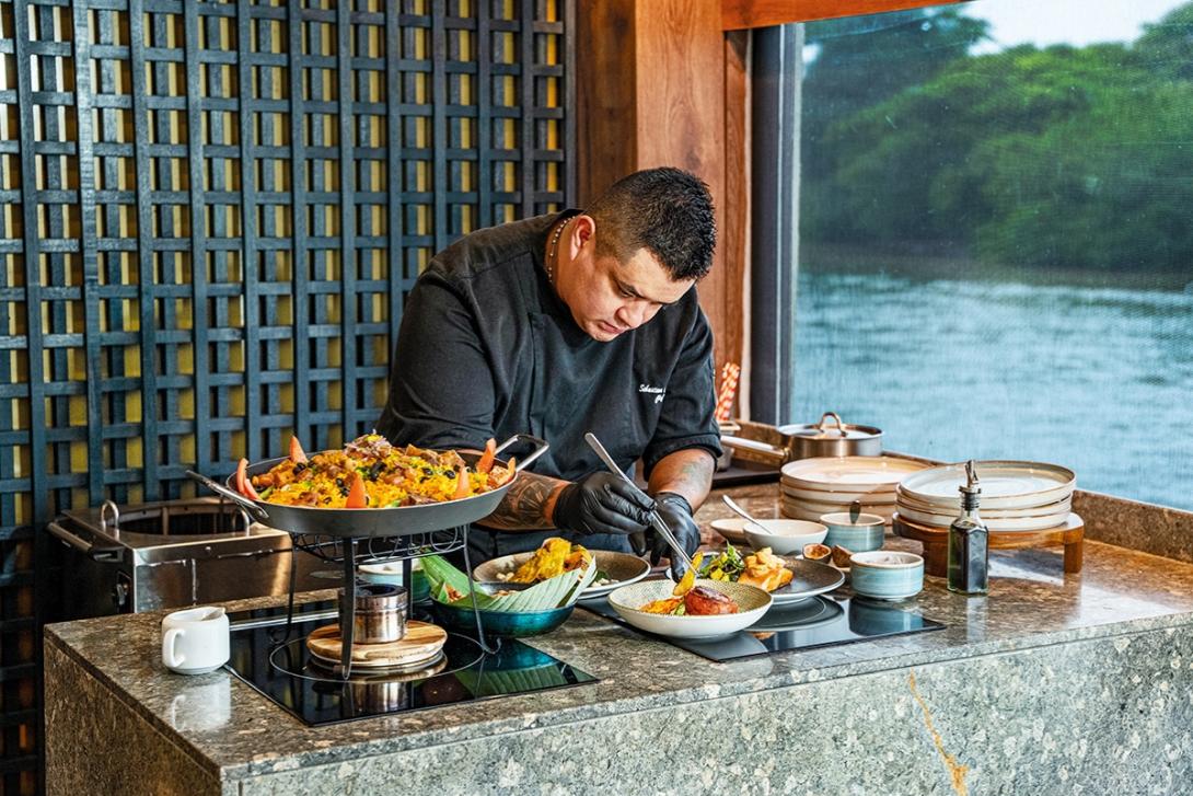 (credit: AmaWaterways / ProColombia) A chef putting together a dish onboard AmaMagdalena