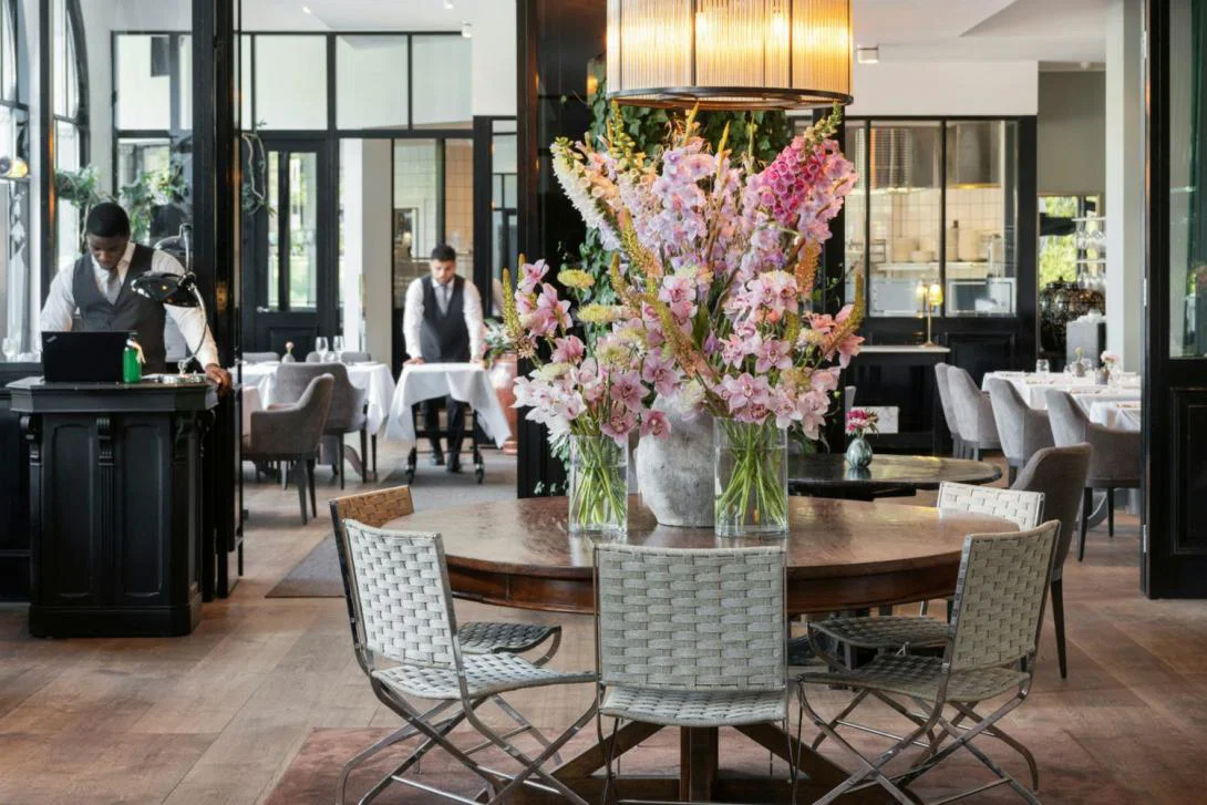 Bright, airy restaurant with pink flower arrangement