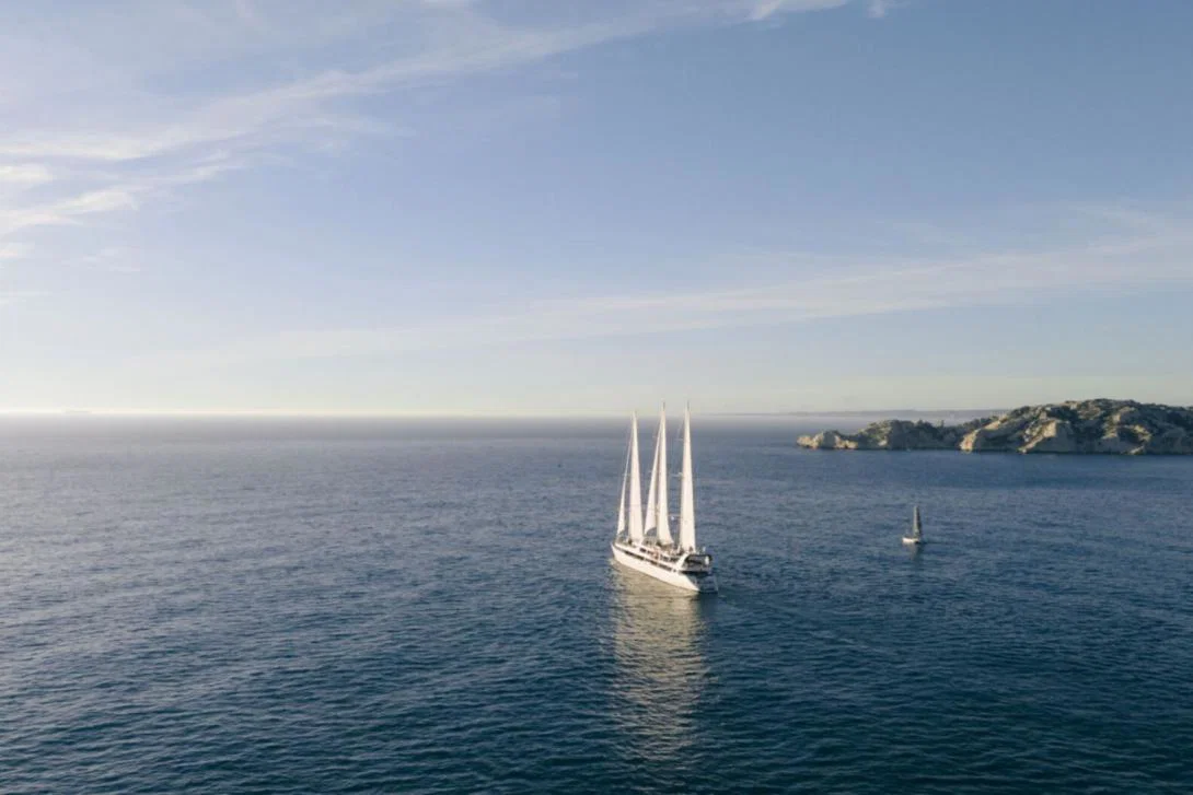 Ship with mast sails in sea