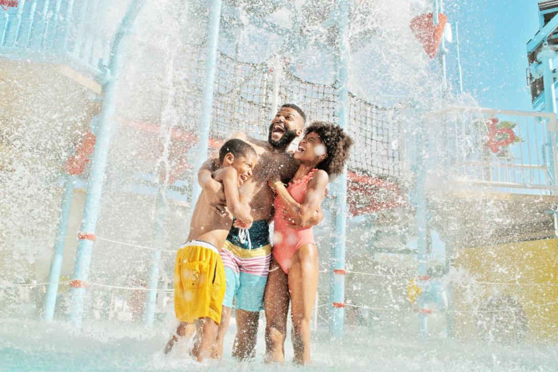 VISIT FLORIDA Dad and children playing in water park