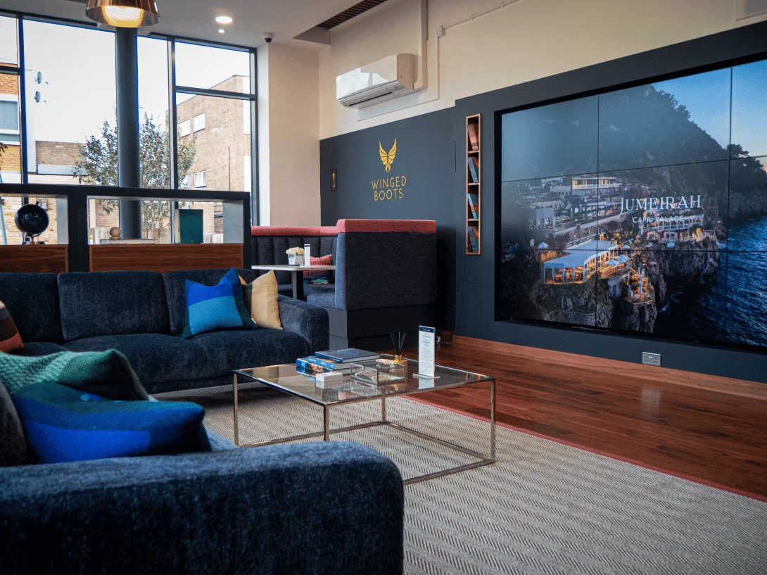 Winged Boots store in Shenfield Travel lounge for clients with large TV screen