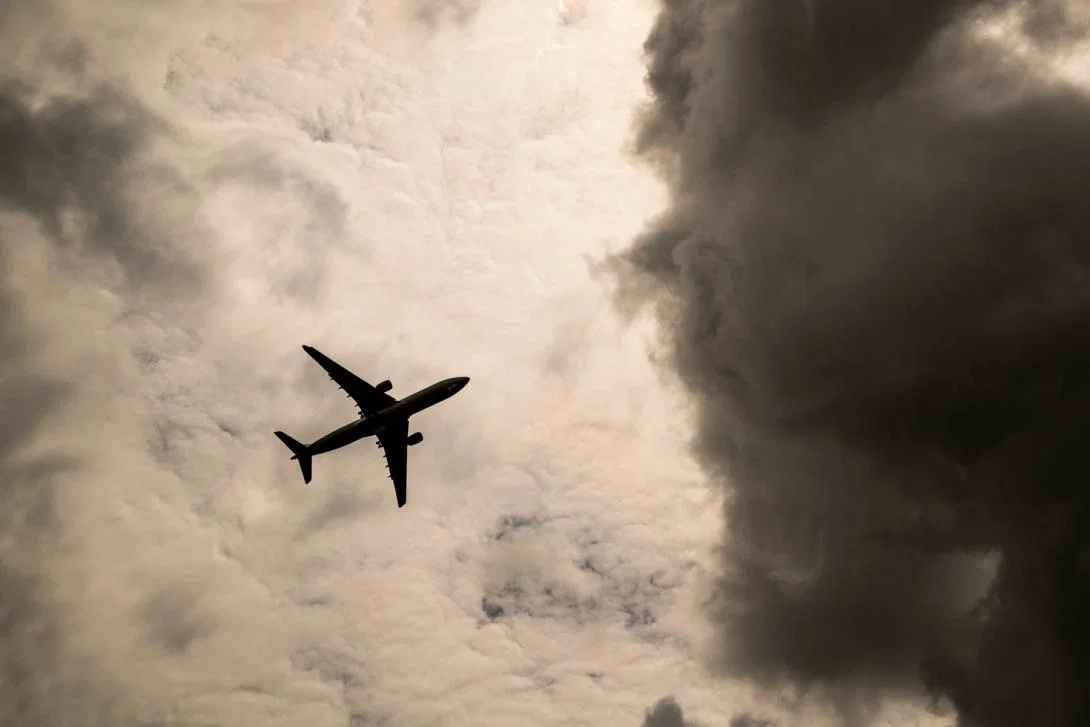 An aircraft flying towards a storm cloud