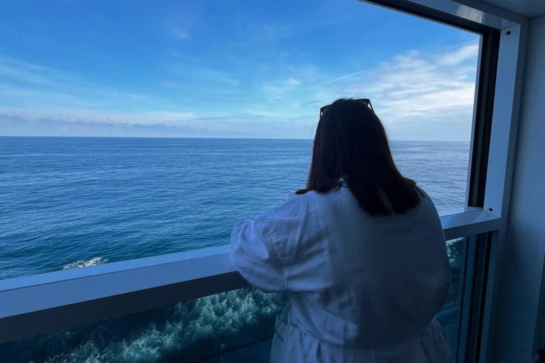 Eleanor Roche, Travel Counsellors Eleanor Roche looking over her Infinite Veranda balcony in her robe