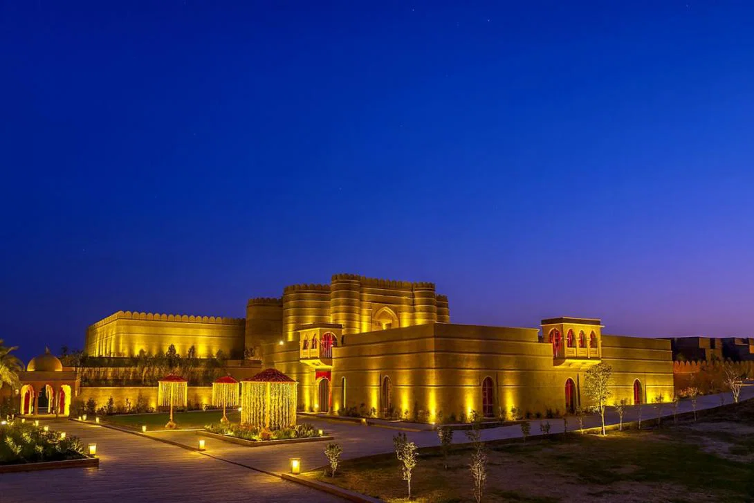 Exterior of lit up luxury hotel at night