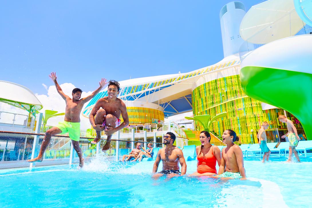 Group of people jumping in pool 