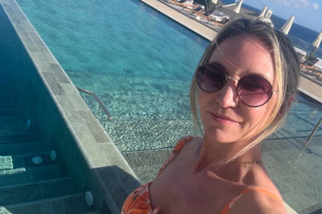 Woman smiling in front of pool