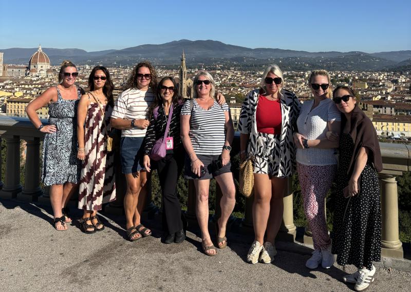 Agents lined up in front of view of Florence from above