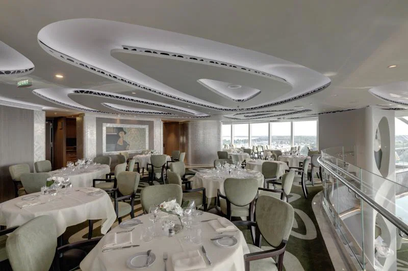 Table and chairs in Yacht Club restaurant with funky roof pattern