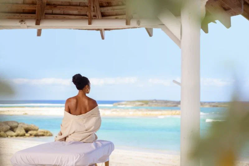 (credit: Nassau & Paradise Island Promotion Board) A woman sitting on an outdoor massage table looking out to sea