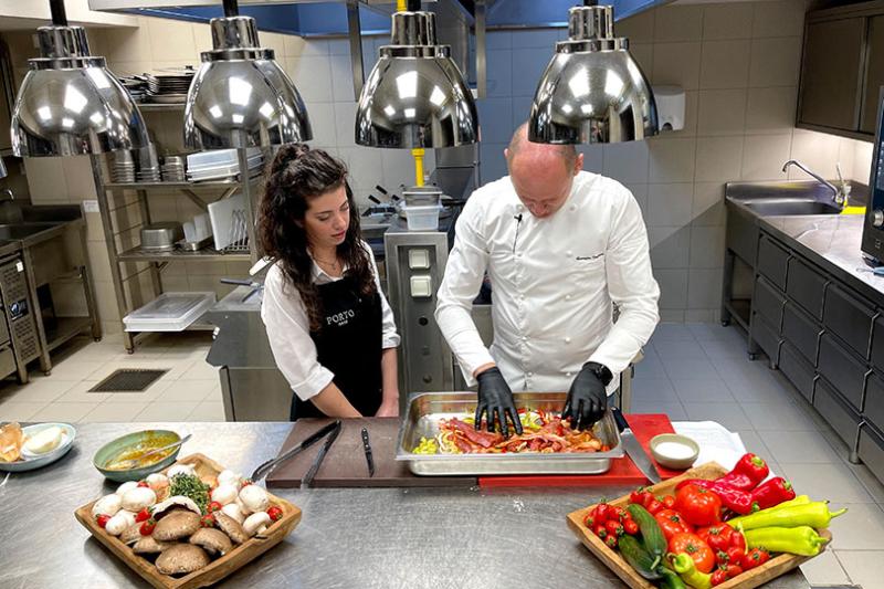 Chef Vagionas shows agents how to prep the pork dish