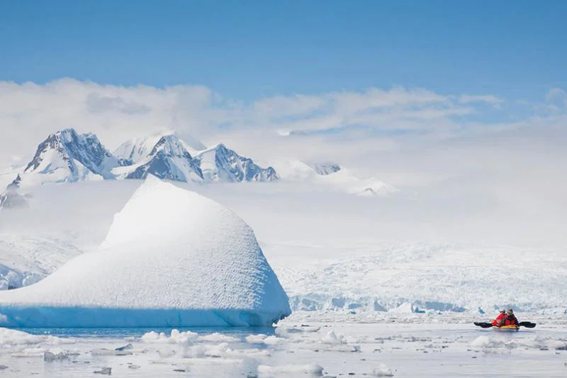 Kayaking alongside icebergs in Antarctica with Cookson Adventures