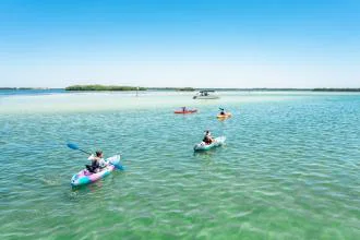 Kayaking on clear blue ocean water